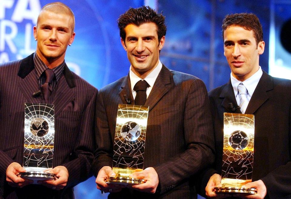 ZURICH, SWITZERLAND: David Beckham (L) of Manchester United, Luis Figo (C) and Raul (R) of Real Madrid pose with the FIFA world player trophy in Zurich, 17 December 2001. Figo finished first in the voting ahead of Beckham (second) and Raul (third). AFP PHOTO KEYSTONE/WALTER BIERI/WB/mr (Photo credit should read WALTER BIERI/AFP/Getty Images)