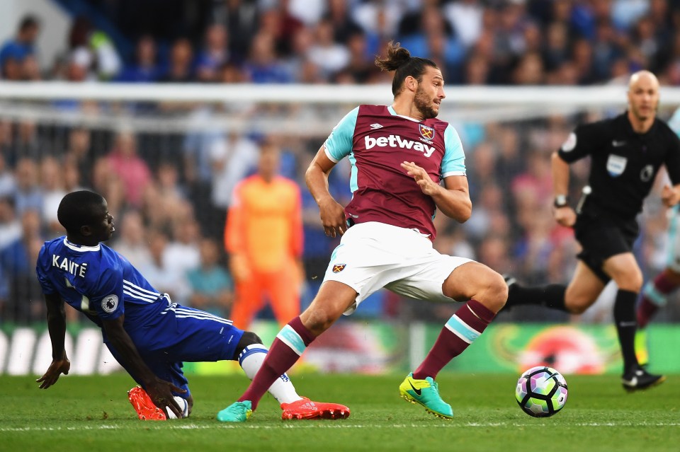  Chelsea new boy N'Golo Kante challenges Andy Carroll for the ball