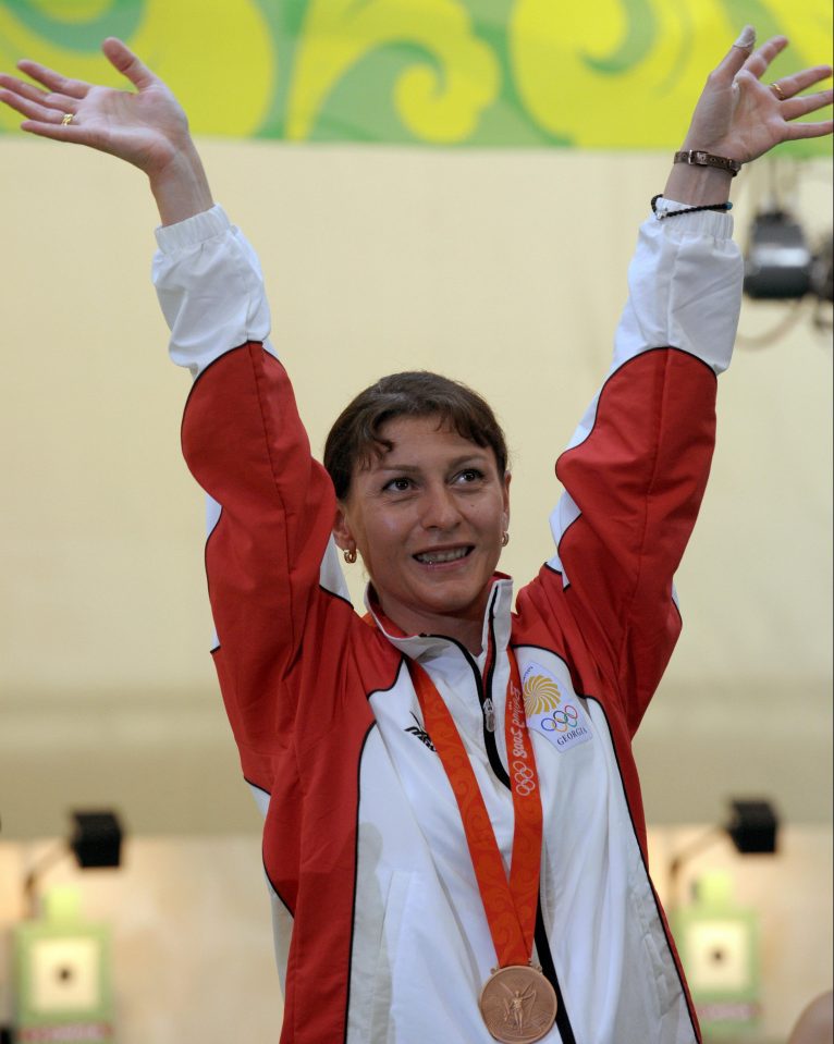 Bronze medalist Nino Salukvadeze of Georgia celebrates on the podium of the women's 10m Air Pistol at the 2008 Beijing Olympic Games