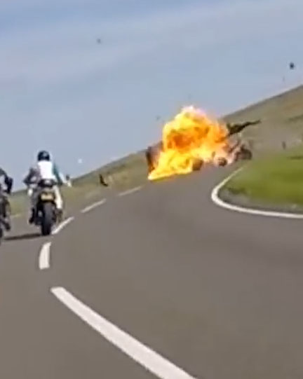 A fireball erupts on the tarmac, killing both motorcyclists