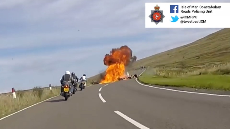 Another of the bikes following behind is forced off the road by the flames