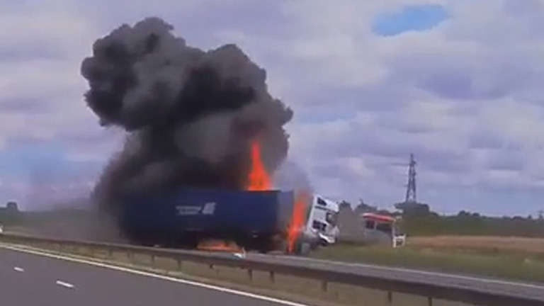  The inferno raged by the side of the motorway as terrified motorists feared the worst