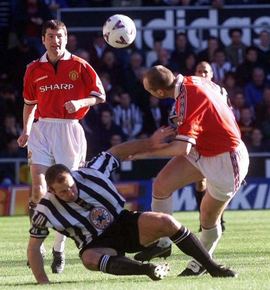 Stam gets clattered by Alan Shearer with Red Devils team-mate Irwin behind him