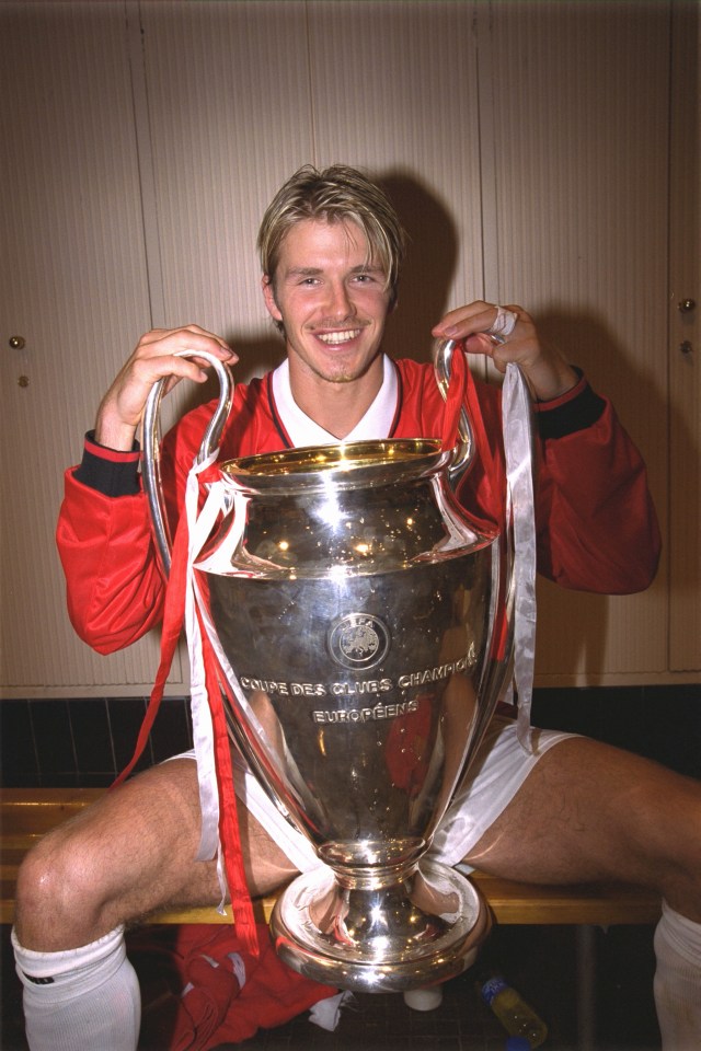 BARCELONA, SPAIN - MAY 26: David Beckham with the European Cup in the dressing room after the UEFA Champions League Final between Bayern Munich v Manchester United at the Nou camp Stadium on 26 May, 1999 in Barcelona, Spain. Bayern Munich 1 Manchester United 2. (Photo by John Peters/Manchester United via Getty Images)