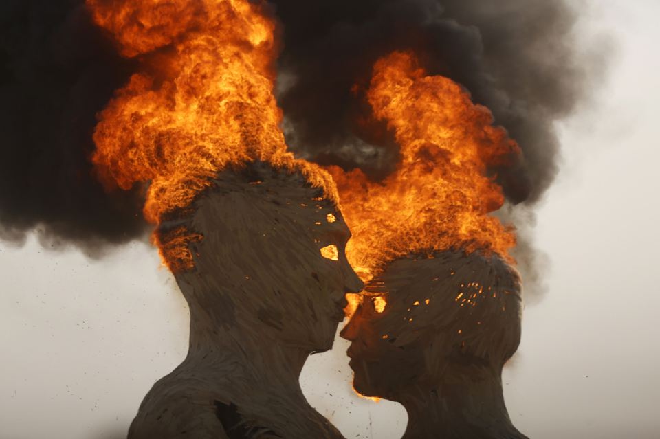  Face to face ... Burning sculpture "Embrace" goes up in flames