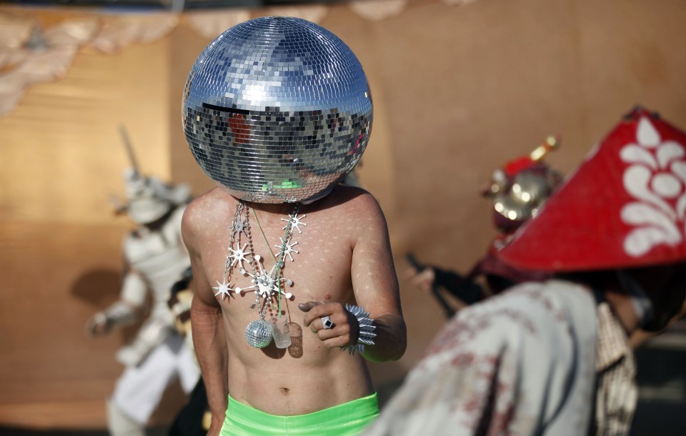  Shining personality ... Disco man "Ciberfy" dances at sunrise during Burning Man