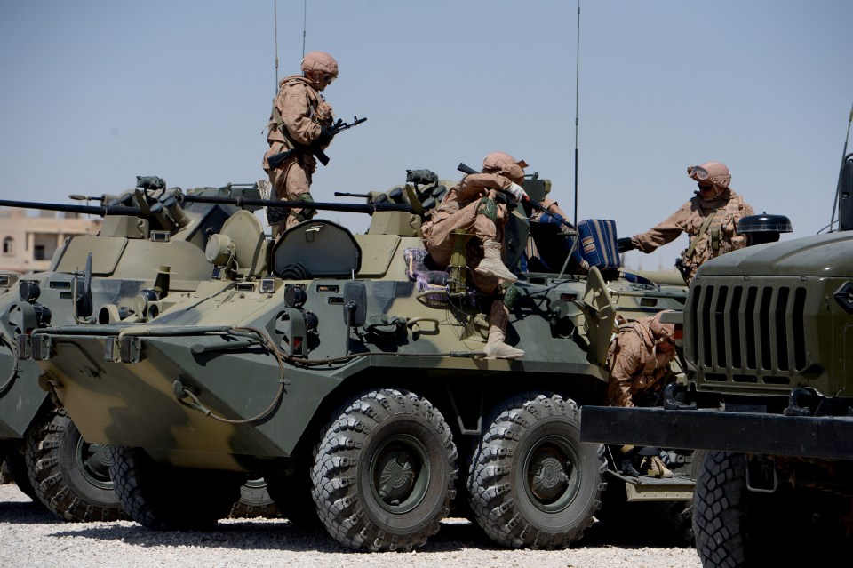  Russian army soldiers sit on a military vehicle in Palmyra, Syria. Putin has used the conflict as a test-run for his new weaponry