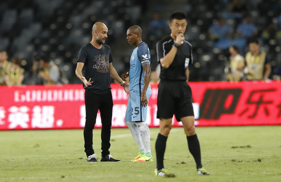  Pep Guardiola talking with Fernandinho after a friendly against Dortmund