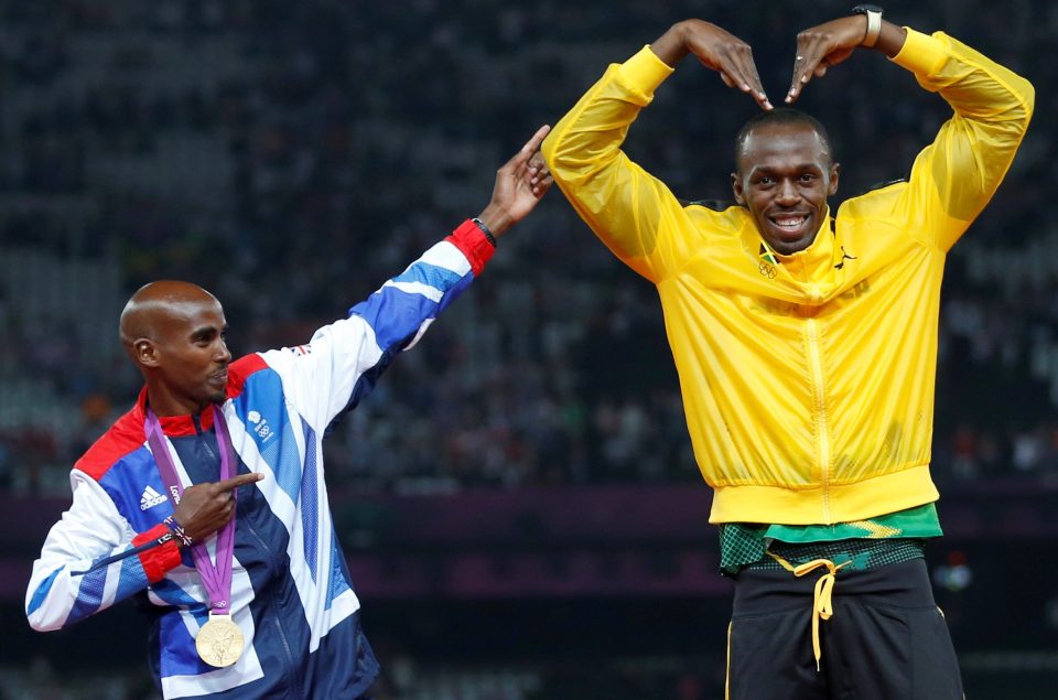 Jamaica's Usain Bolt (R) celebrates with Britain's Mo Farah