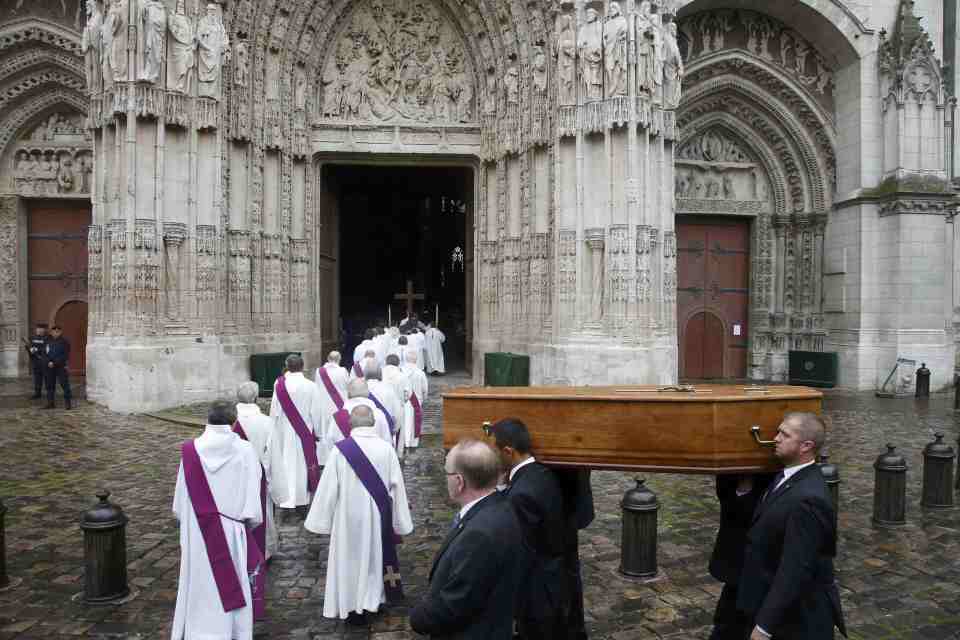 Pallbearers carry Father Hamel's body into the cathedral in Rouen