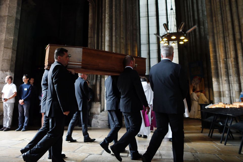 Hundreds braved downpours to pay their respects to the popular priest