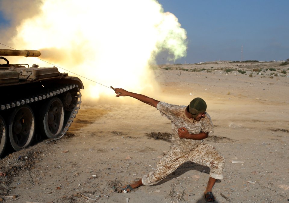 A fighter of Libyan forces allied with the U.N.-backed government fires a shell with Soviet made T-55 tank at Islamic State fighters in Sirte,