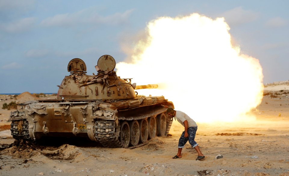 A fighter of Libyan forces allied with the U.N.-backed government fires a shell with Soviet made T-55 tank at Islamic State fighters in Sirte