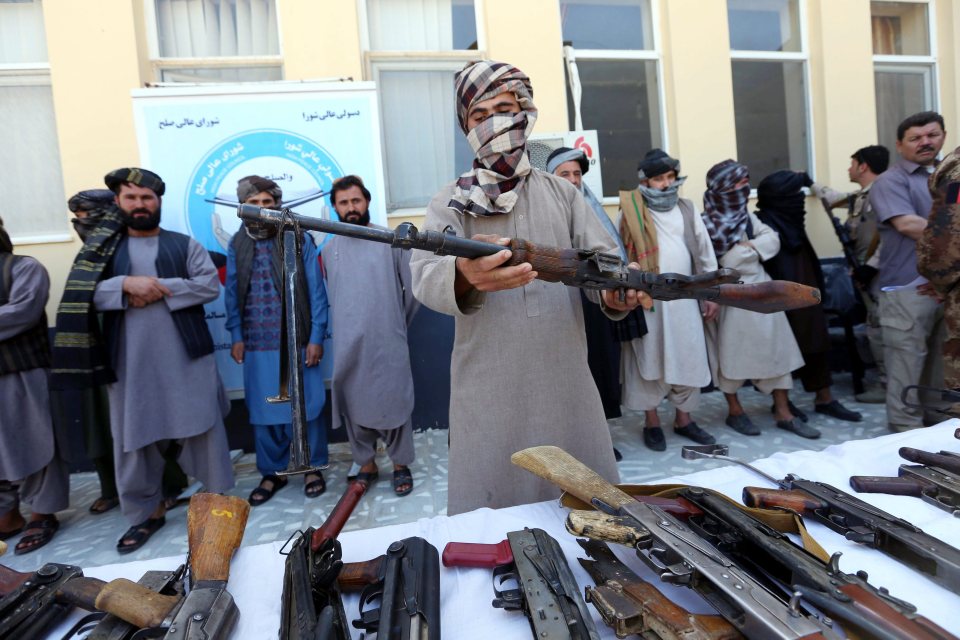  Former Taliban militants surrender their weapons during a reconciliation ceremony in Herat on August 3