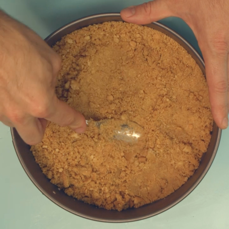  Add butter and flatten down into a cake tin