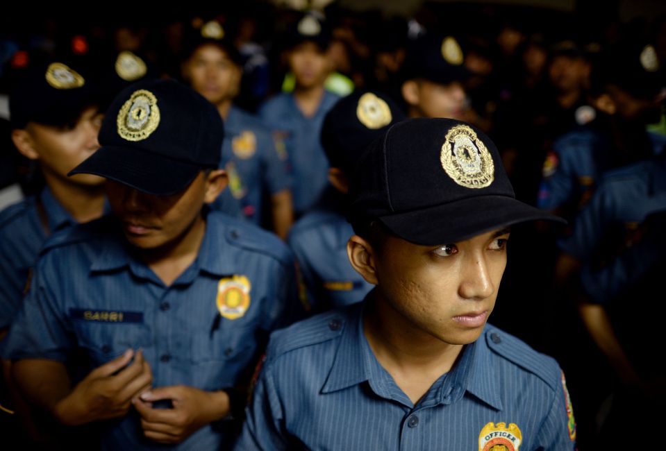  Police officers standing in formation before the start of operation Oplan RODY, a campaign to rid the streets of drunks and shirtless men