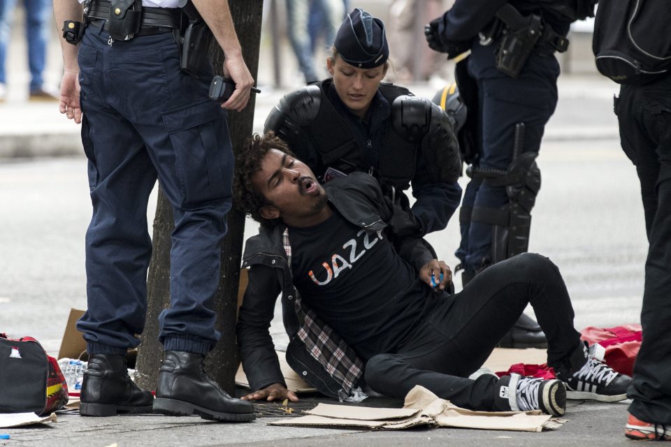  A refugee faints during the chaotic police raid today