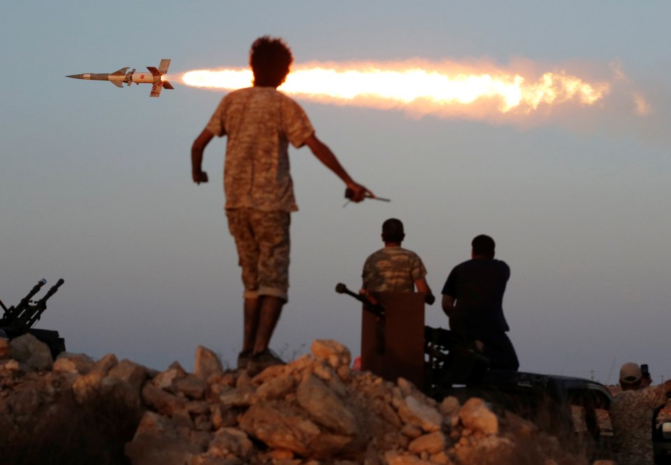 Fighters of Libyan forces allied with the U.N.-backed government fire a rocket at Islamic State fighters in Sirte, Libya