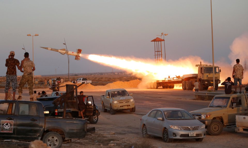 Fighters of Libyan forces allied with the U.N.-backed government fire a rocket at Islamic State fighters in Sirte, Libya