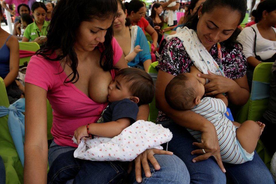  A mother breastfeeds her tot in Venezuela