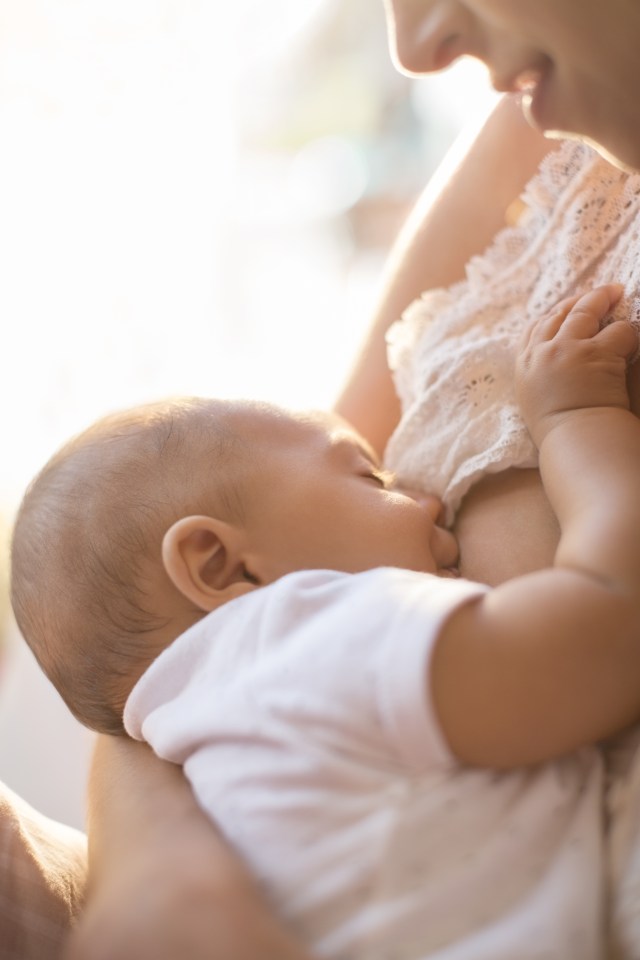 Mother breast-feeding baby boy