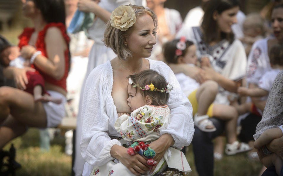  A woman breastfeeds her eighteen-month-old daughter Anastasia at an event promoting the freedom of mothers to breastfeed in public, at the Village Museum in Bucharest, Romania