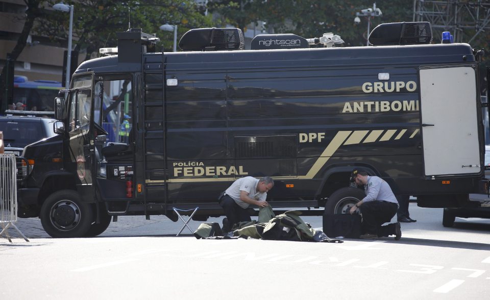  Bomb squad agents control the area near the finish line of the cycling race