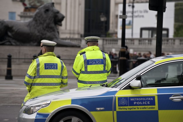 Metropolitan police officers and car on duty in central London.