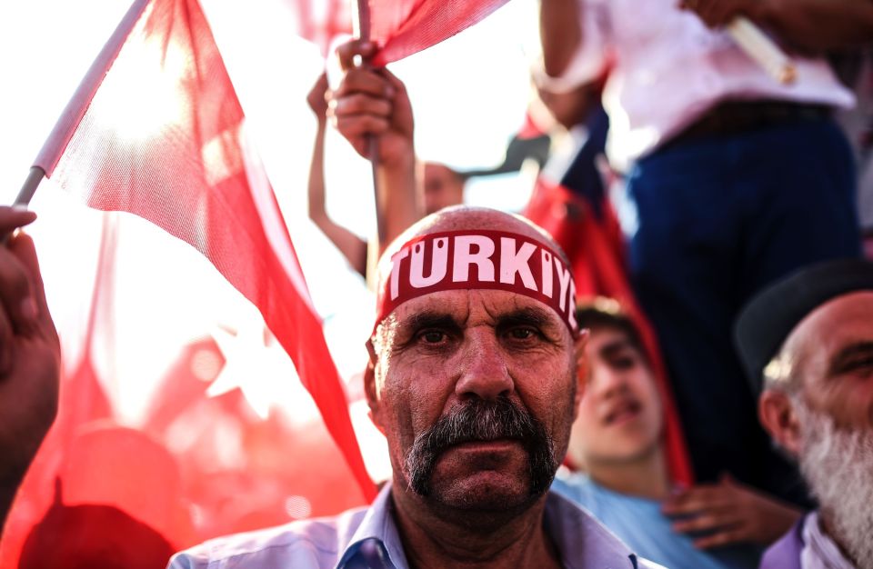 A man wears a headband reading "Turkey"