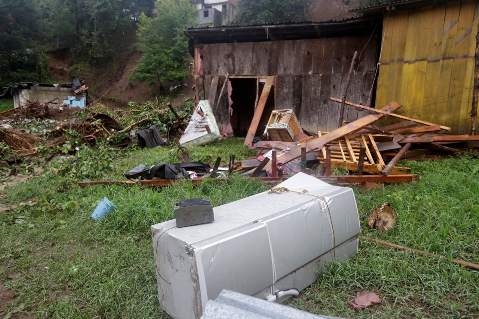  A refrigerator is seen next to houses damaged by heavy showers caused by the passing of Tropical Storm Earl, in the town of Huauchinango