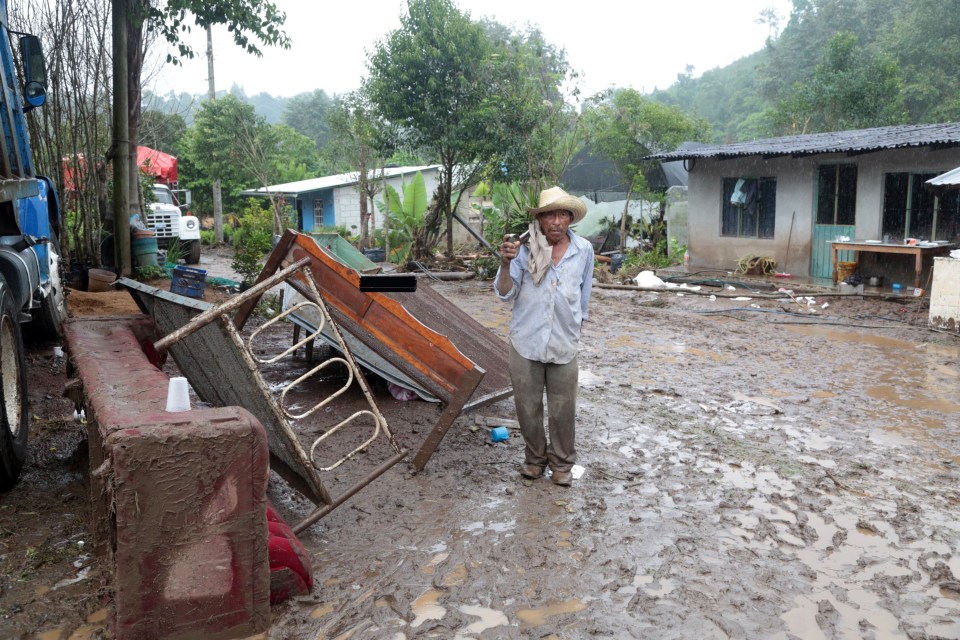  A man stands in his devastated community of Tlaola as the number of people missing remains unclear