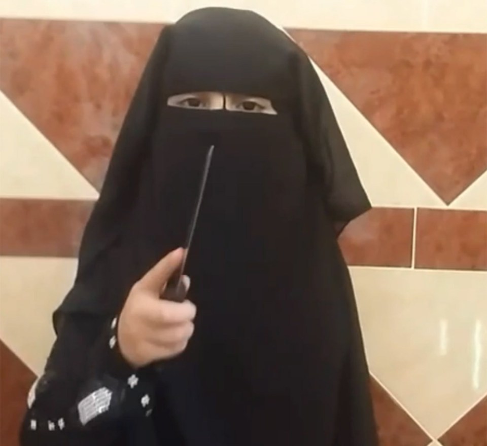 The niqab-covered little girl points her knife at the camera in the chilling propaganda video