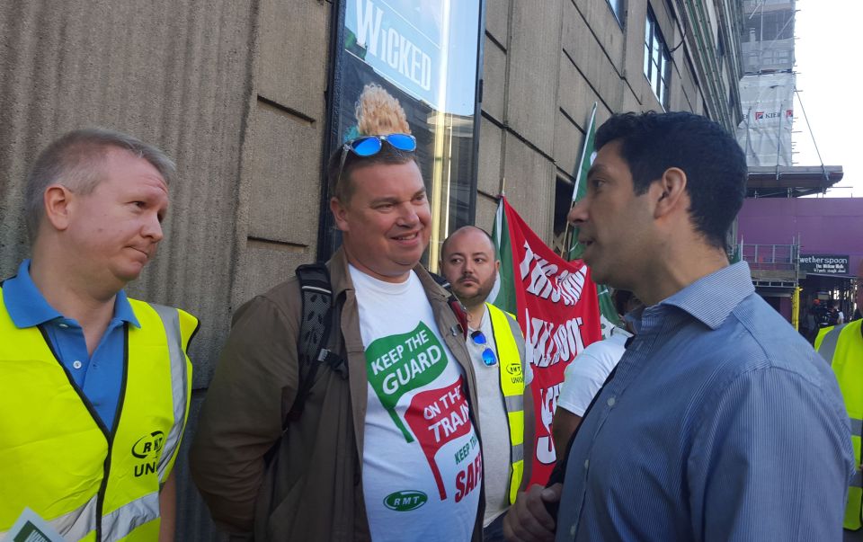 A fuming passenger confronts RMT workers outside Victoria station in London 