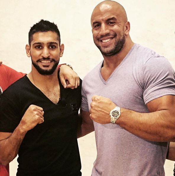 Tam Khan, pictured with boxing world champion Amir Khan, has told Muslims to 'stop becoming militants and extremists'