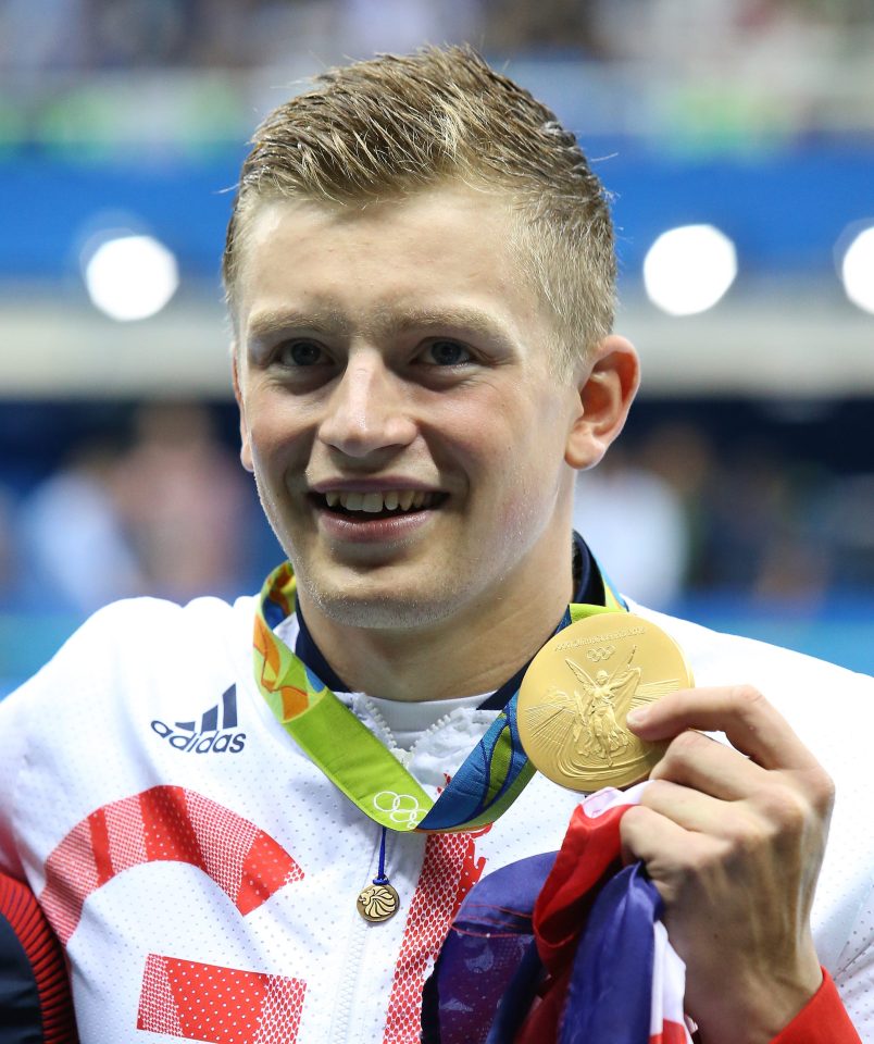  Adam Peaty poses with gold during medal ceremony