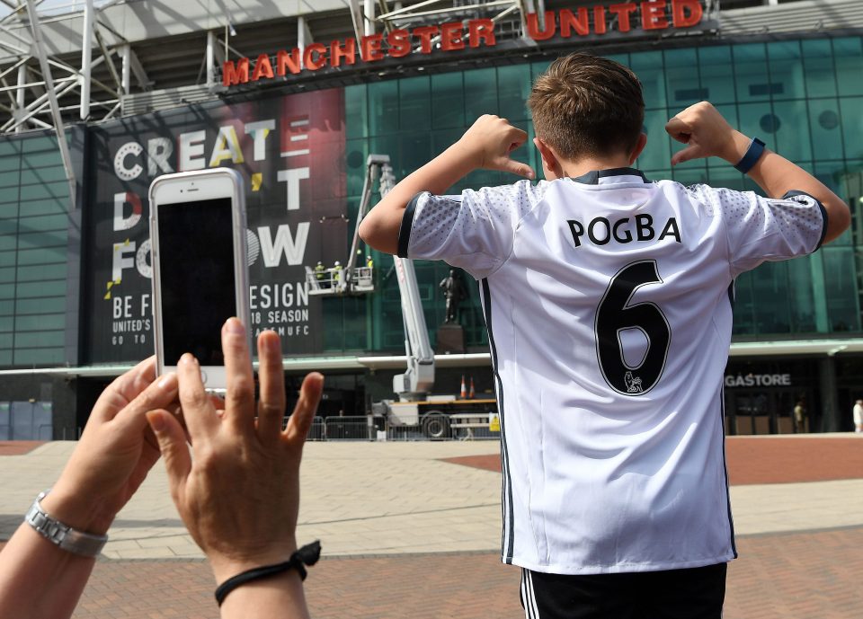 A United fan poses with a Pogba top on the brink of the new Prem season