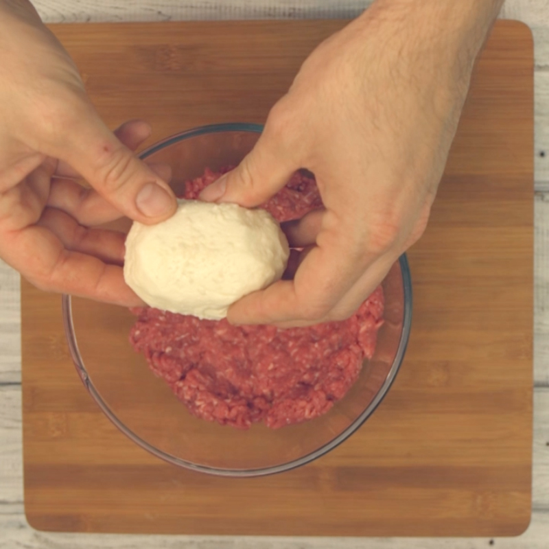  Place whole ball of mozzarella into mince