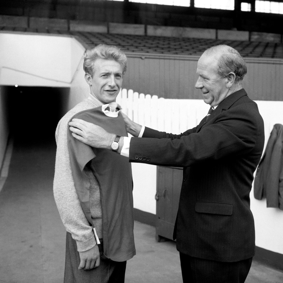 Manchester United Manager Matt Busby measures new signing Denis Law for the club's shirt in 1960