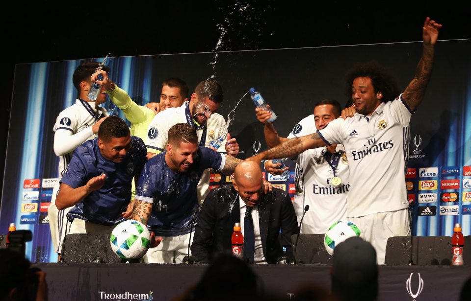  Real Madrid boss Zinedine Zidane is soaked in water while talking to the press