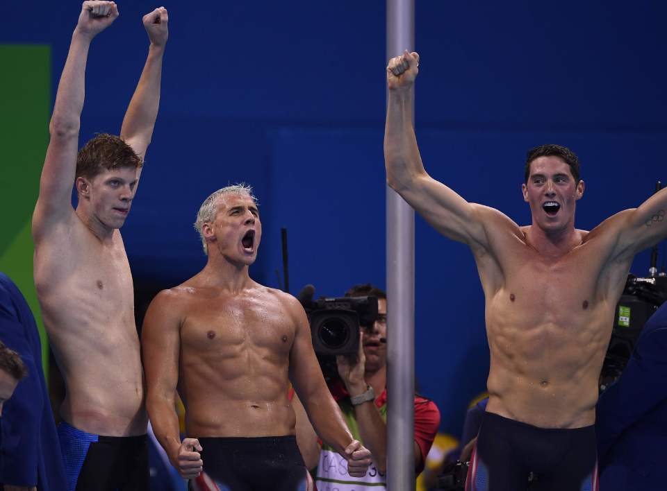 The 32-year-old celebrates his relay win, which was his 12th medal in four Olympics