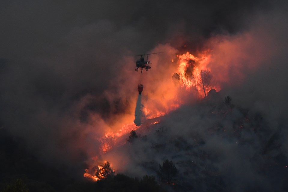  Here, a helicopter can be seen dumping water on a blaze near Vitrolles, southern France, earlier this week