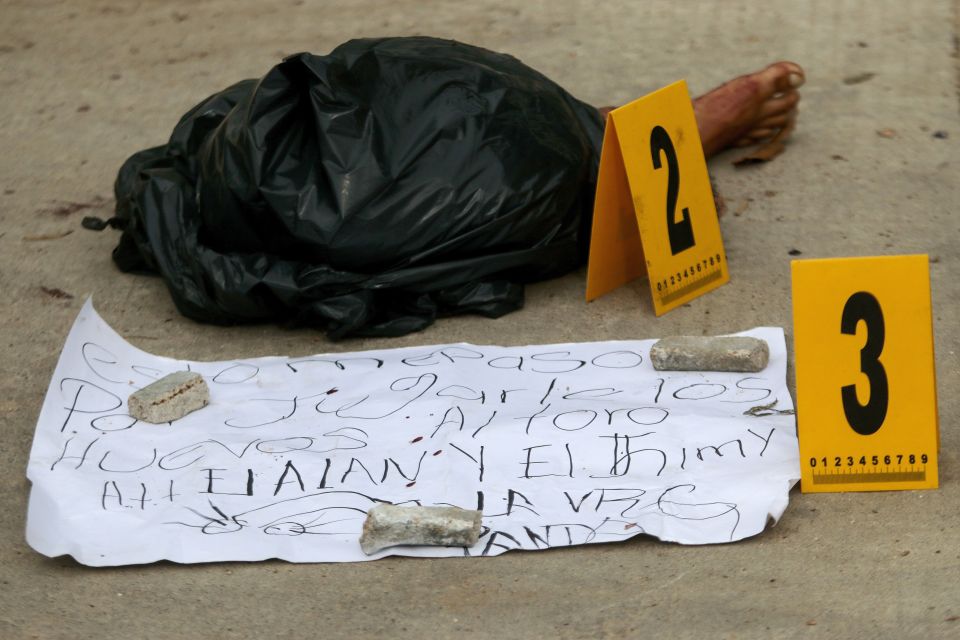  Parts of a dismembered body lie on a street in Acapulco - a resort popular with tourists