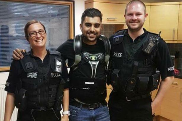  Hinesh posed with officers while wearing his back brace