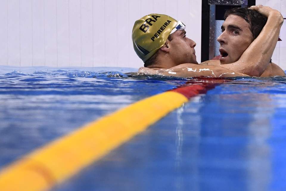 Phelps is congratulated by Brazil's Thiago Pereira , who started strong before fading