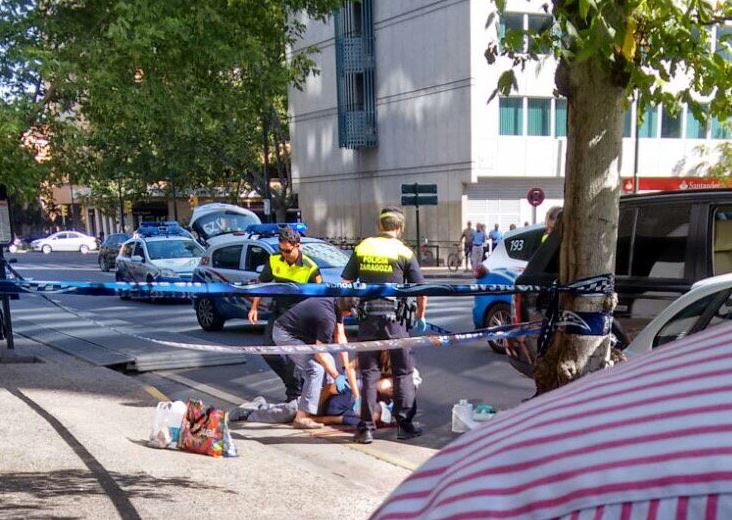  Medics race to treat a man following a shooting outside a shopping centre in the city of Zaragoza