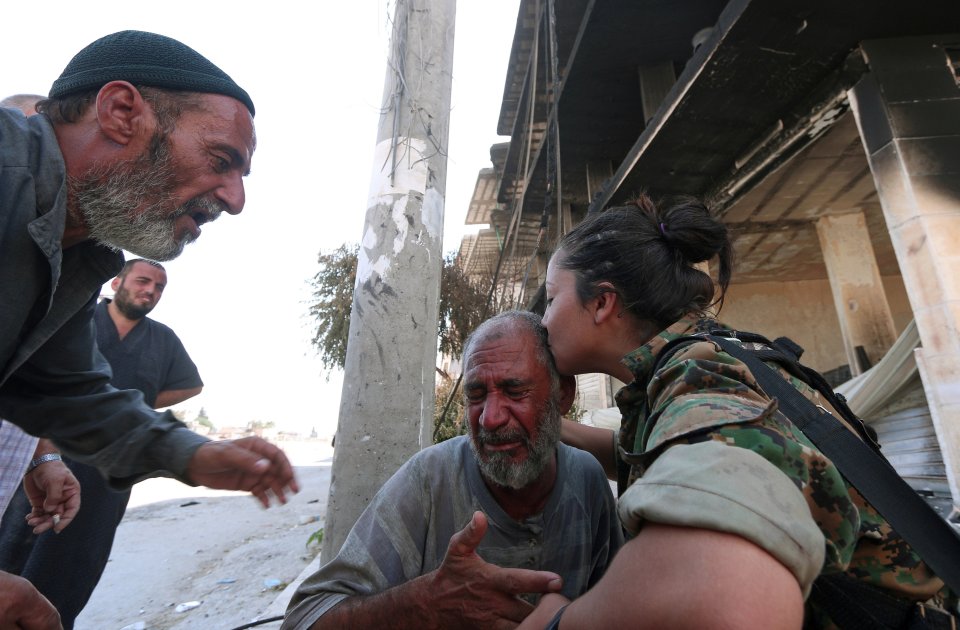  An SDF soldier comforts an emotional civilian