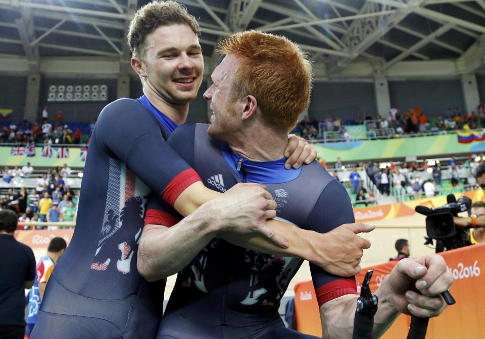 Ed Clancy and Owain Doull share a jubilant hug after winning team pursuit gold