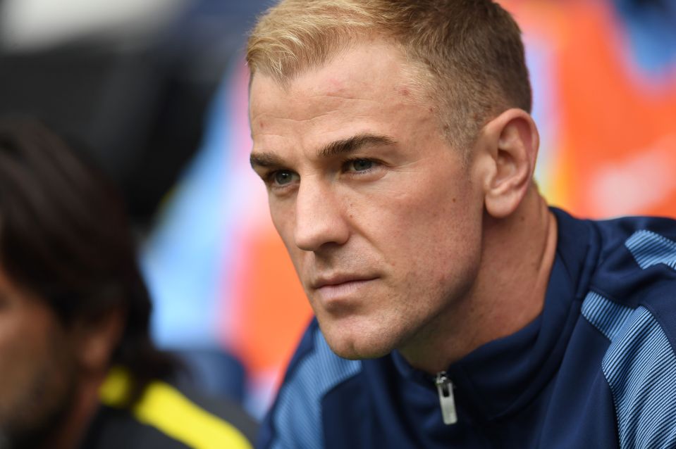 A sour-faced Joe Hart watches on from the bench as he is dropped for the first game of the season