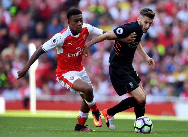 Iwobi tussles for possession with Liverpool's Adam Lallana in the defeat