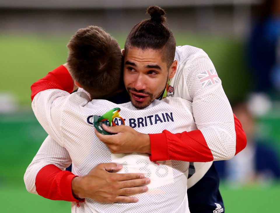  Louis hugged his teammate after receiving their medals